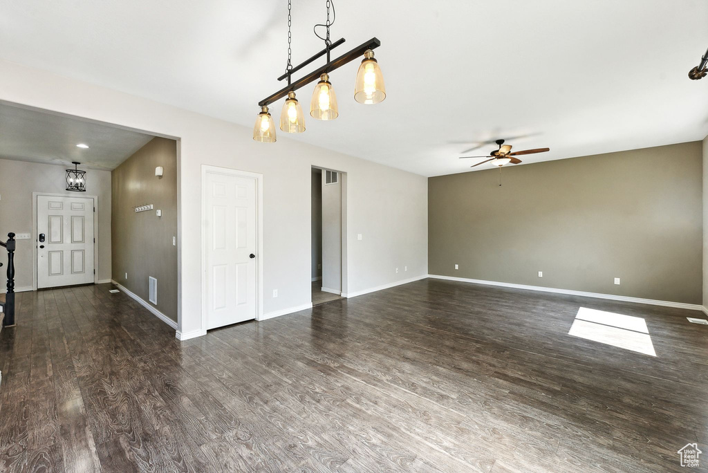 Spare room with ceiling fan and dark hardwood / wood-style flooring