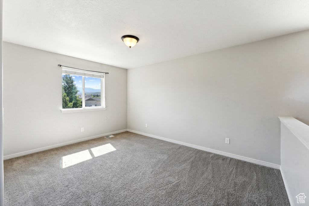 Unfurnished room featuring carpet flooring