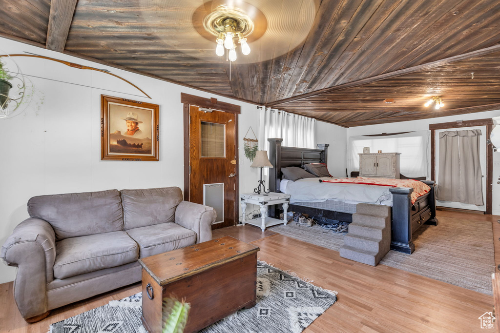 Bedroom featuring vaulted ceiling, wooden ceiling, ceiling fan, and hardwood / wood-style floors