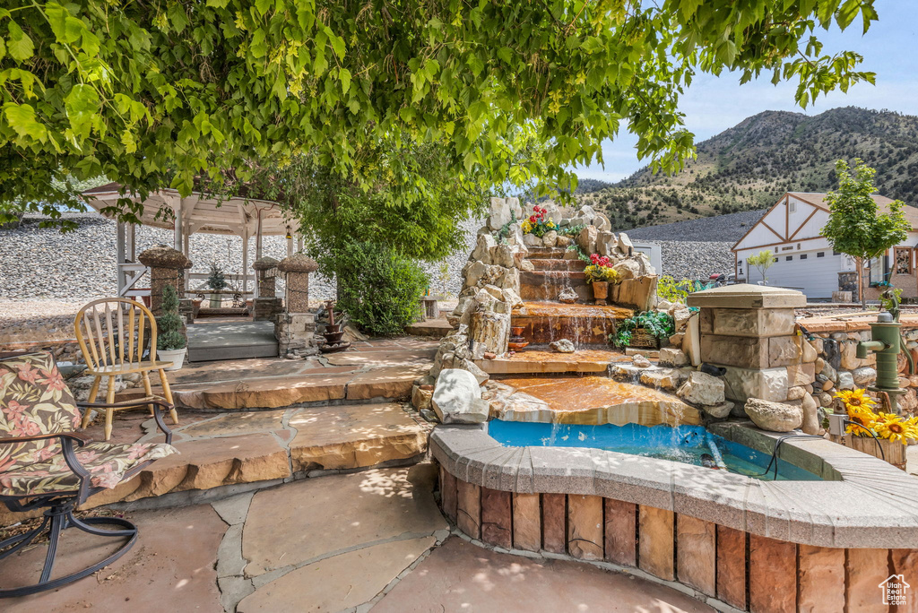 View of swimming pool with a pergola, a patio, and a mountain view