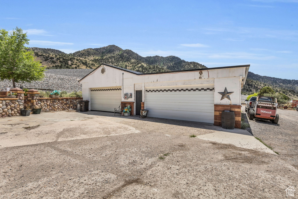 Exterior space with a garage and a mountain view