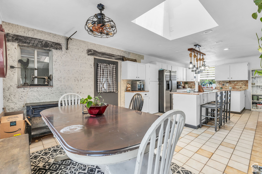 Dining space featuring light tile patterned flooring and a chandelier