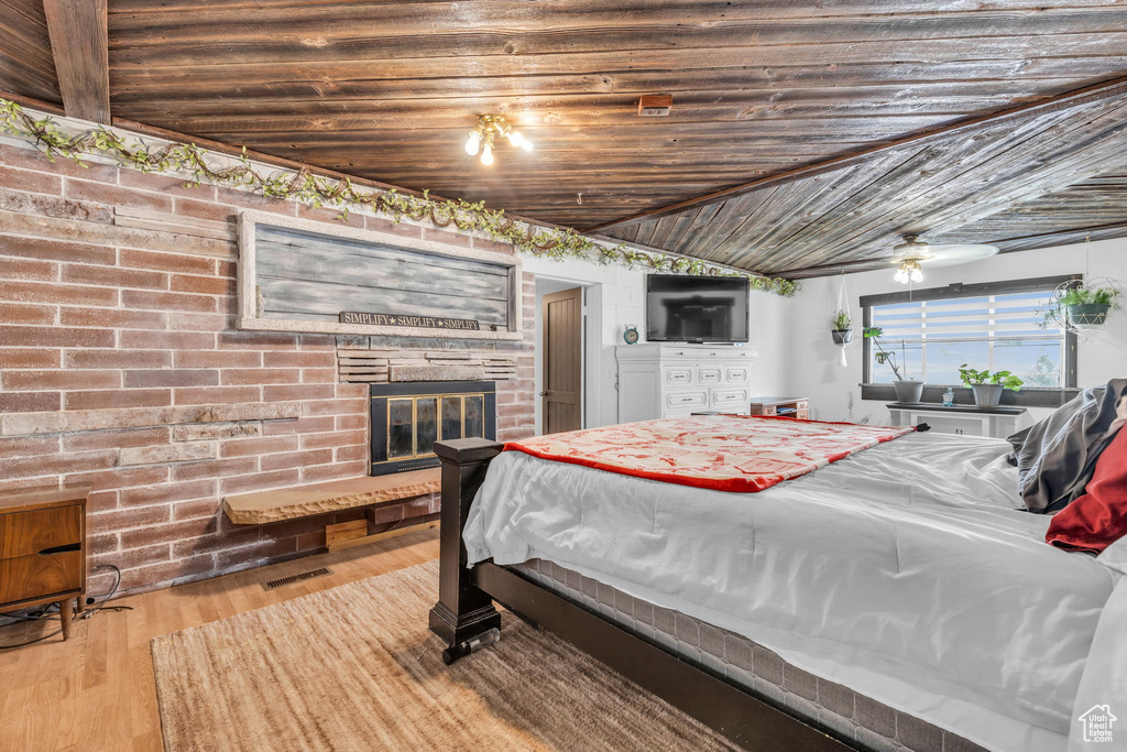 Bedroom featuring lofted ceiling and light hardwood / wood-style flooring