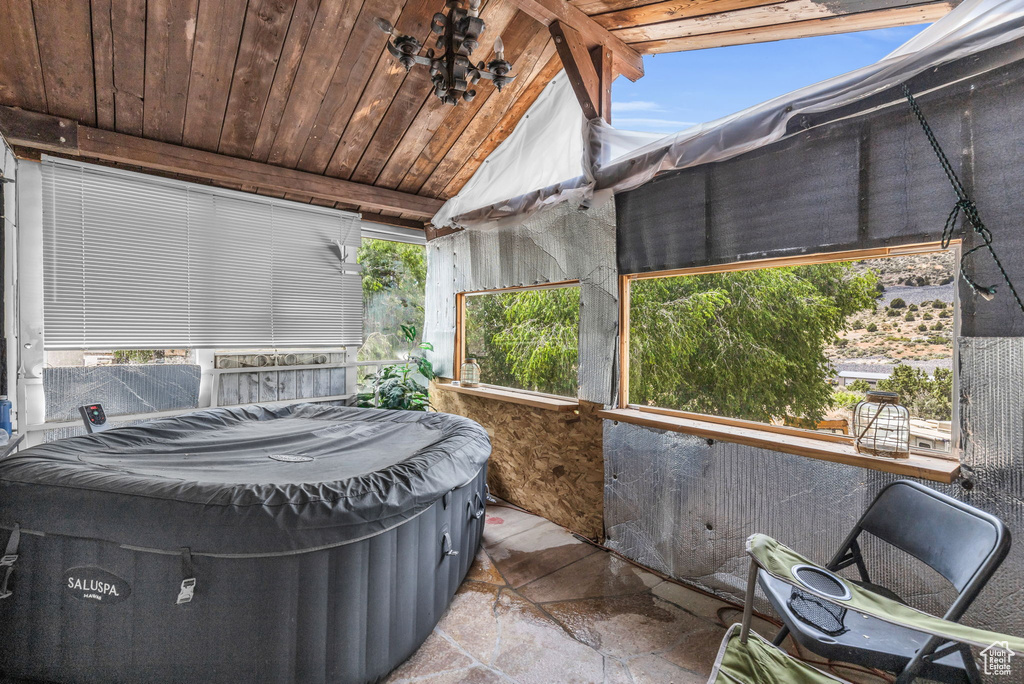 Sunroom / solarium with vaulted ceiling and wooden ceiling