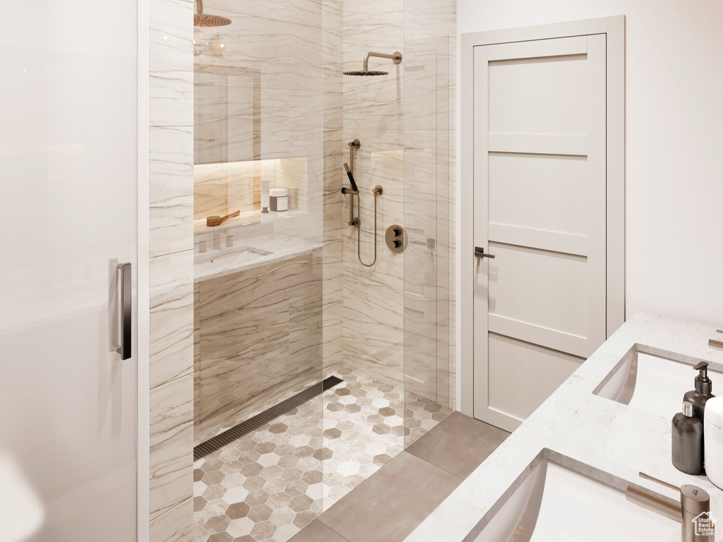 Bathroom featuring double sink and walk in shower