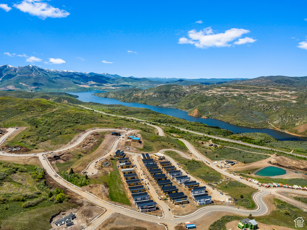 Birds eye view of property featuring a water and mountain view