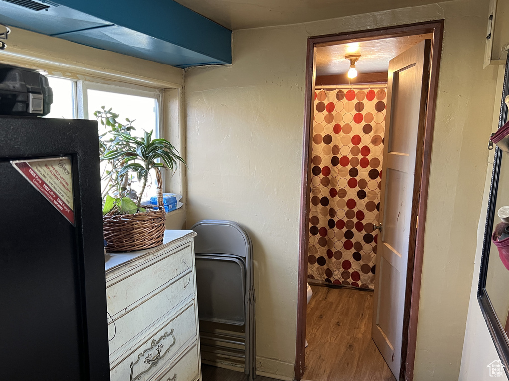 Laundry area with visible vents and wood finished floors