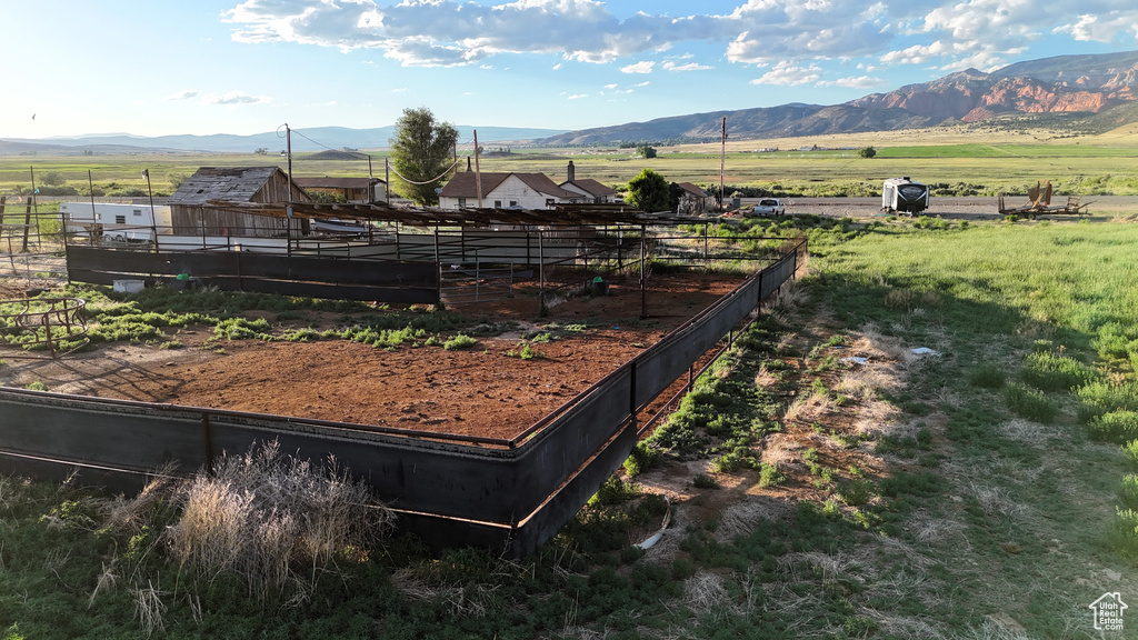 View of yard with a mountain view, a rural view, and an exterior structure