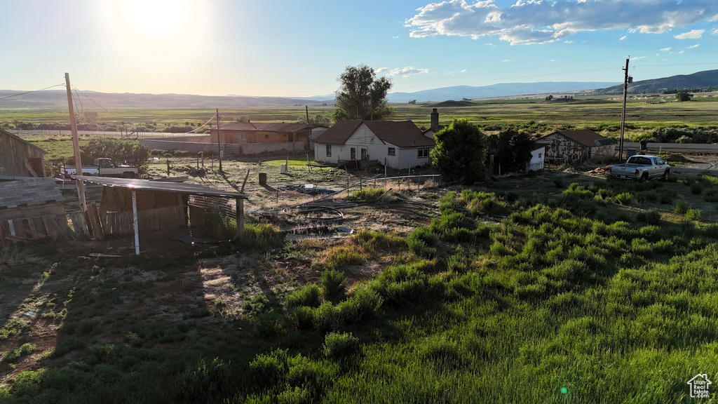 View of yard with a mountain view, a rural view, and fence