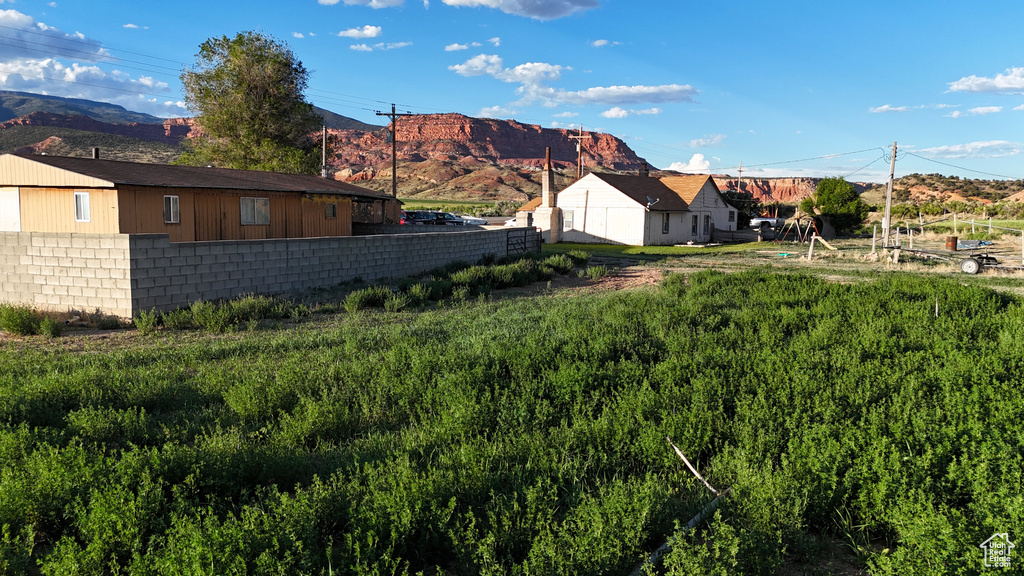 View of yard featuring a mountain view and fence