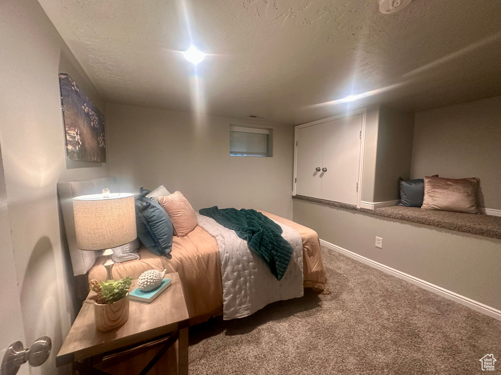 Bedroom with carpet and a textured ceiling