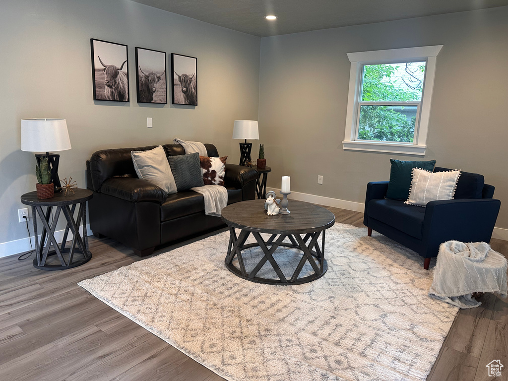 Living room with hardwood / wood-style flooring