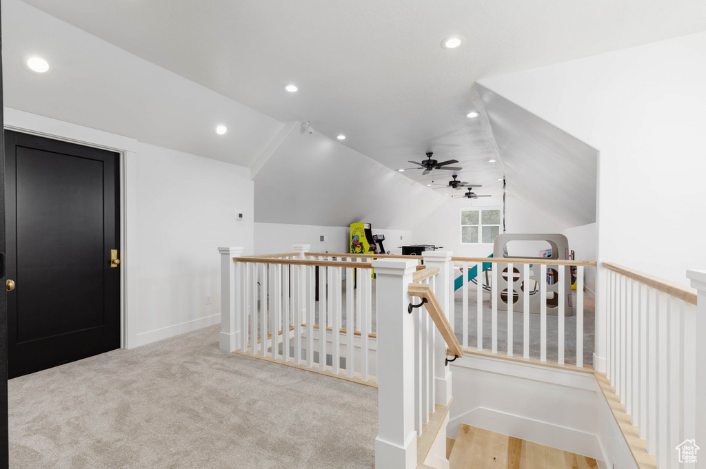 Hall with light carpet and vaulted ceiling