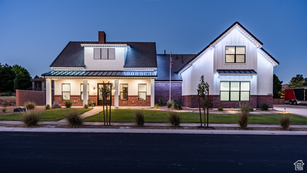 Modern farmhouse style home with a front lawn