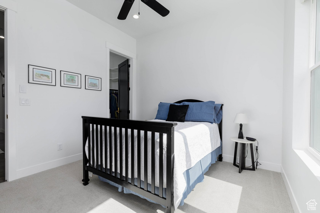 Bedroom featuring ceiling fan and light colored carpet