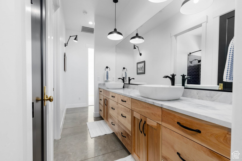 Bathroom featuring tile patterned floors and double sink vanity