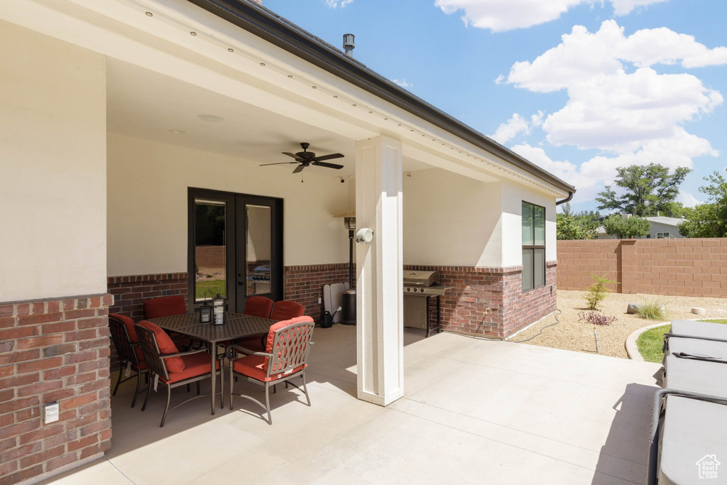 View of patio with grilling area and ceiling fan