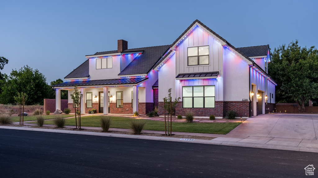 Modern farmhouse style home featuring a front lawn