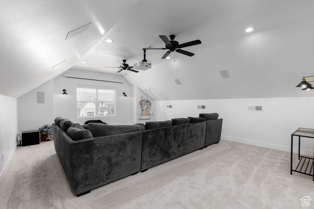 Carpeted cinema with ceiling fan and lofted ceiling