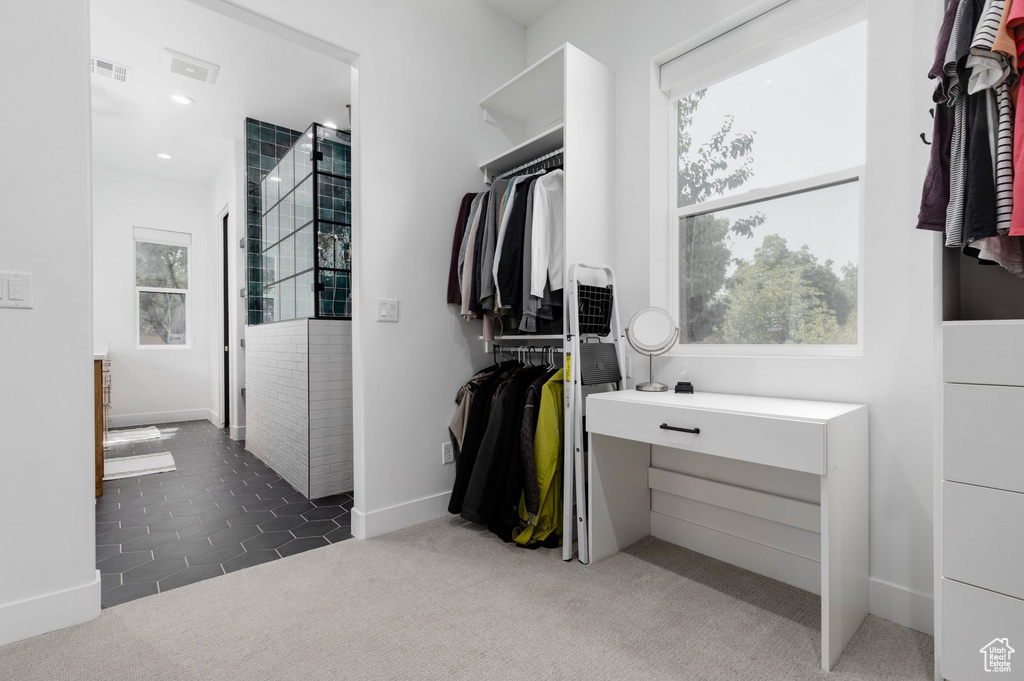 Spacious closet with dark tile patterned floors