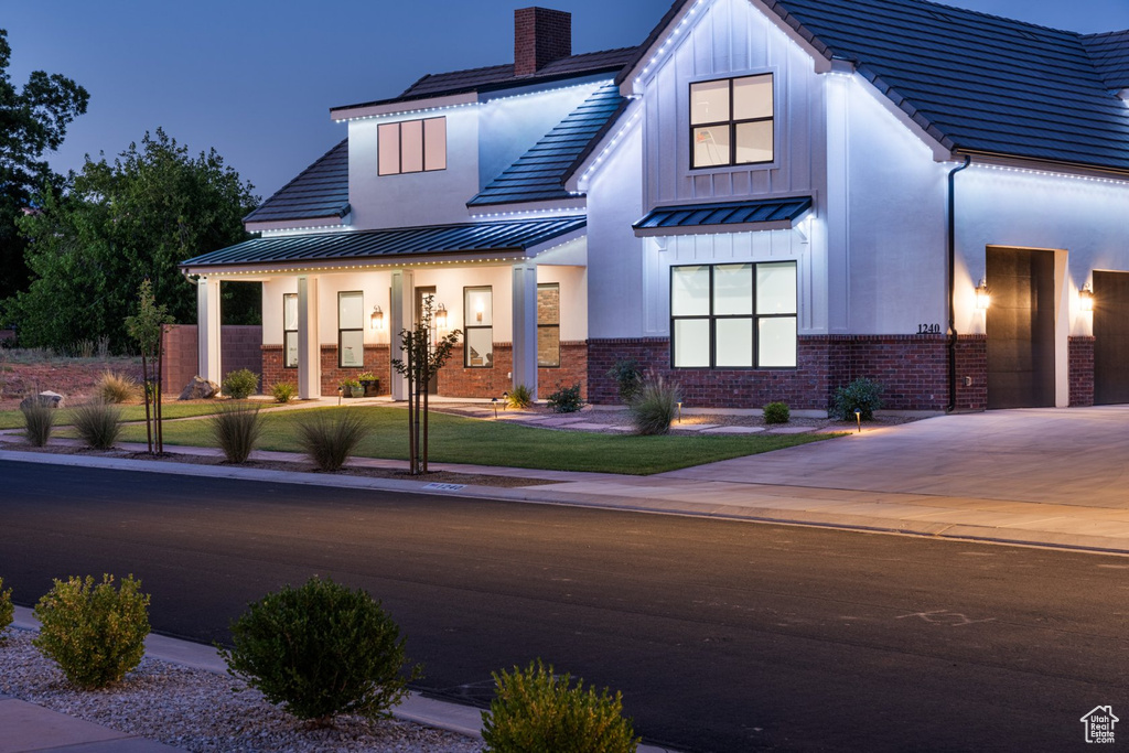 Modern inspired farmhouse with a front yard