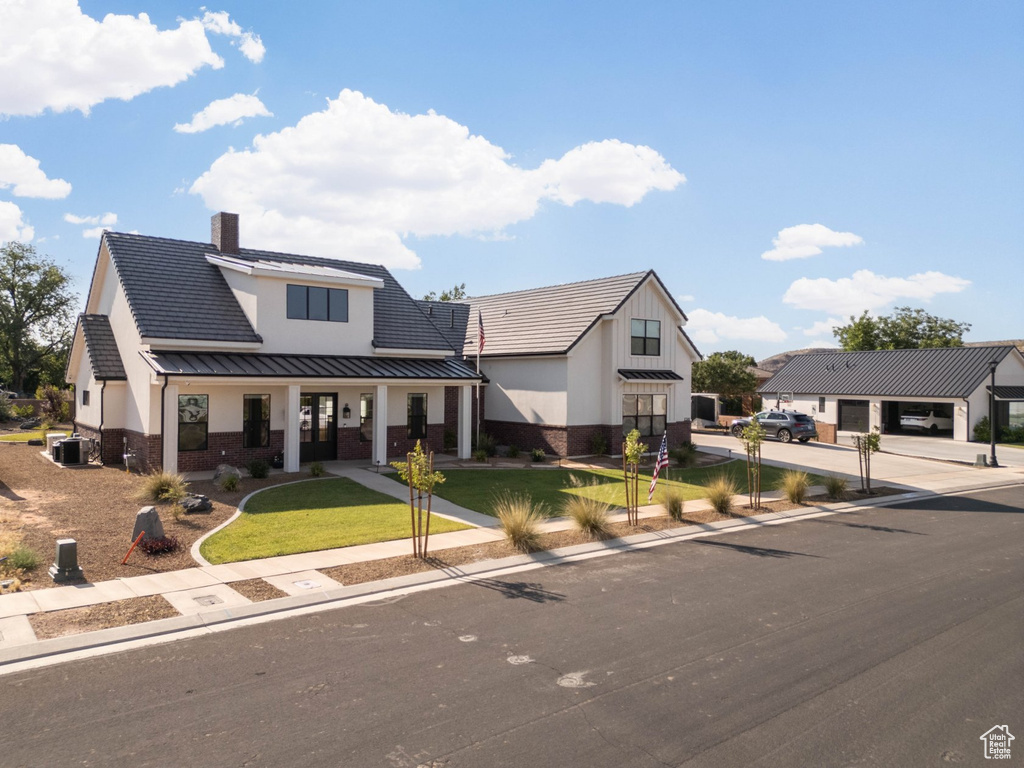 Modern inspired farmhouse with central AC unit and a front yard