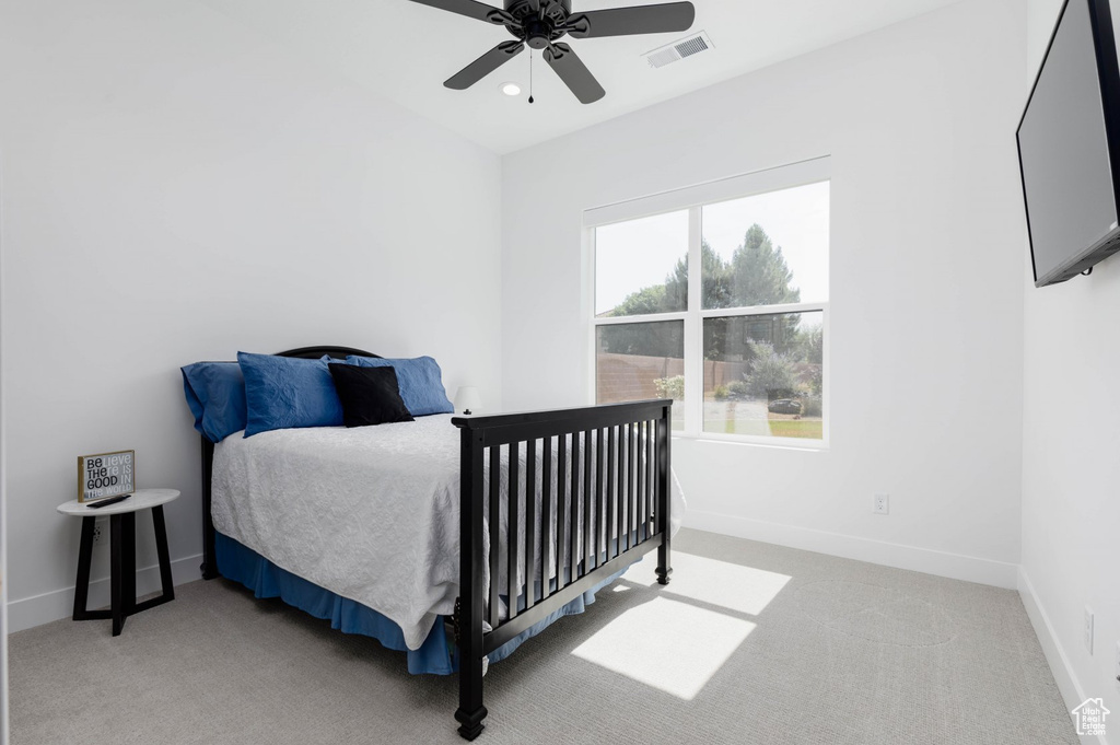 Carpeted bedroom with ceiling fan