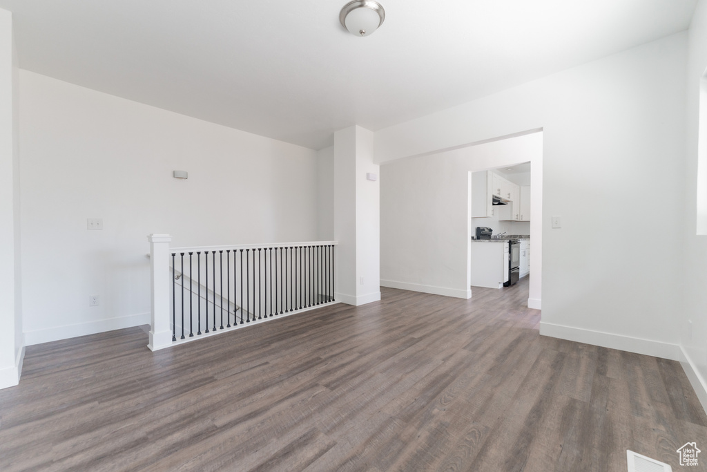 Spare room featuring dark hardwood / wood-style flooring