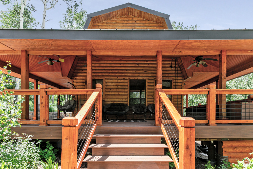 Property entrance with a wooden deck and ceiling fan