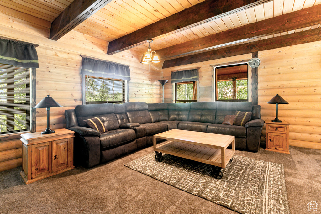 Living room with beamed ceiling, carpet floors, rustic walls, and wood ceiling