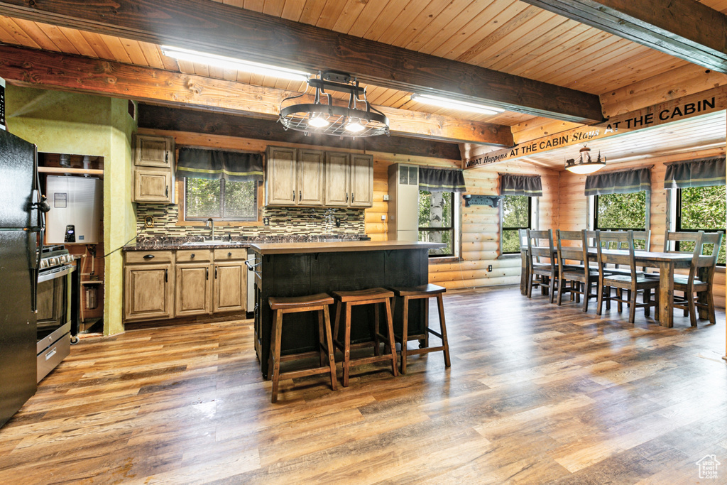 Kitchen featuring light hardwood / wood-style floors, wooden ceiling, a healthy amount of sunlight, and beamed ceiling