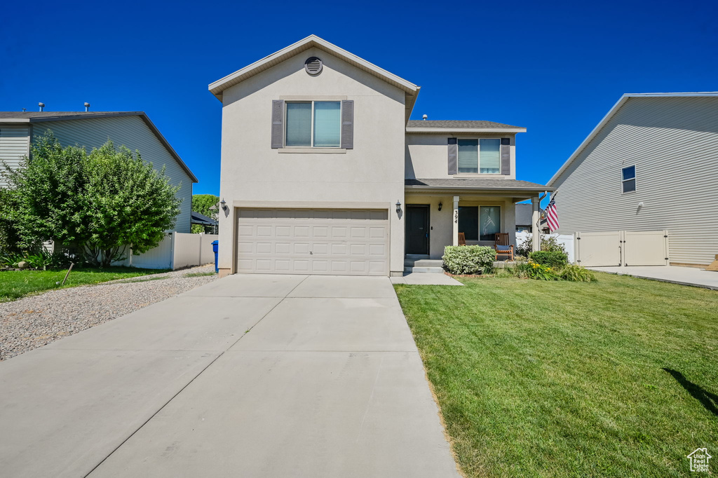 View of front of home featuring a garage and a front yard