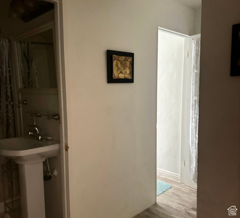 Hallway featuring light hardwood / wood-style floors and sink