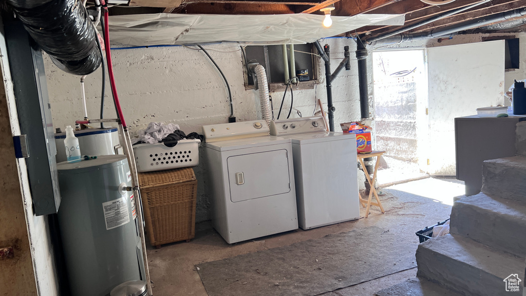 Interior space featuring water heater and washing machine and dryer