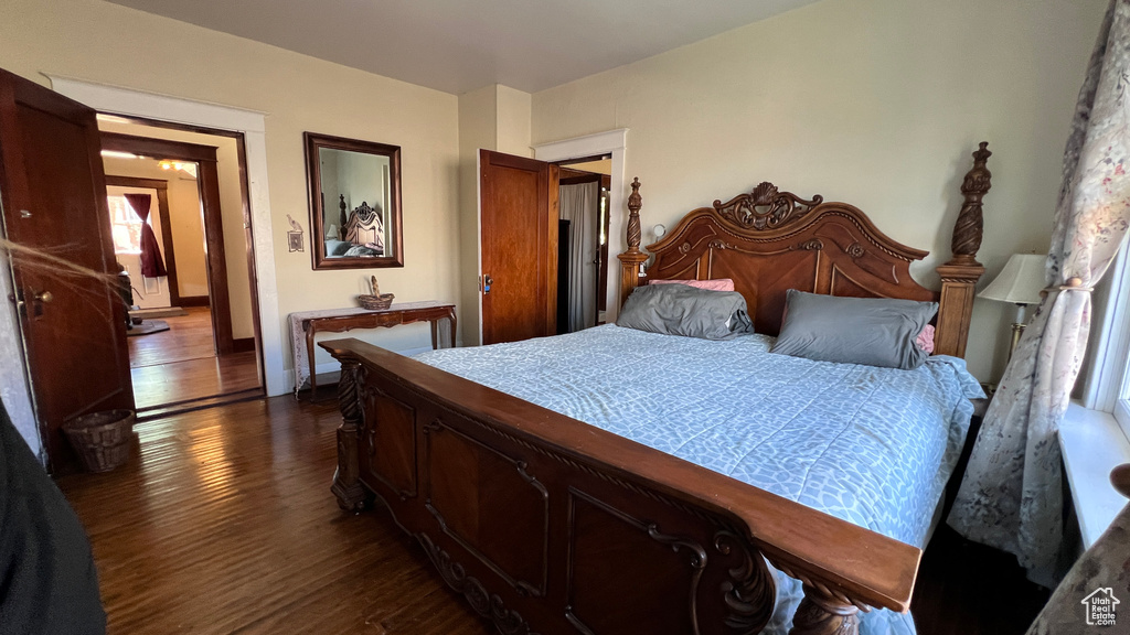 Bedroom with dark hardwood / wood-style floors