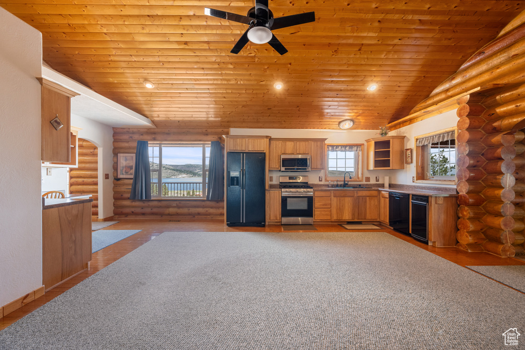 Kitchen featuring log walls, ceiling fan, black appliances, wooden ceiling, and sink