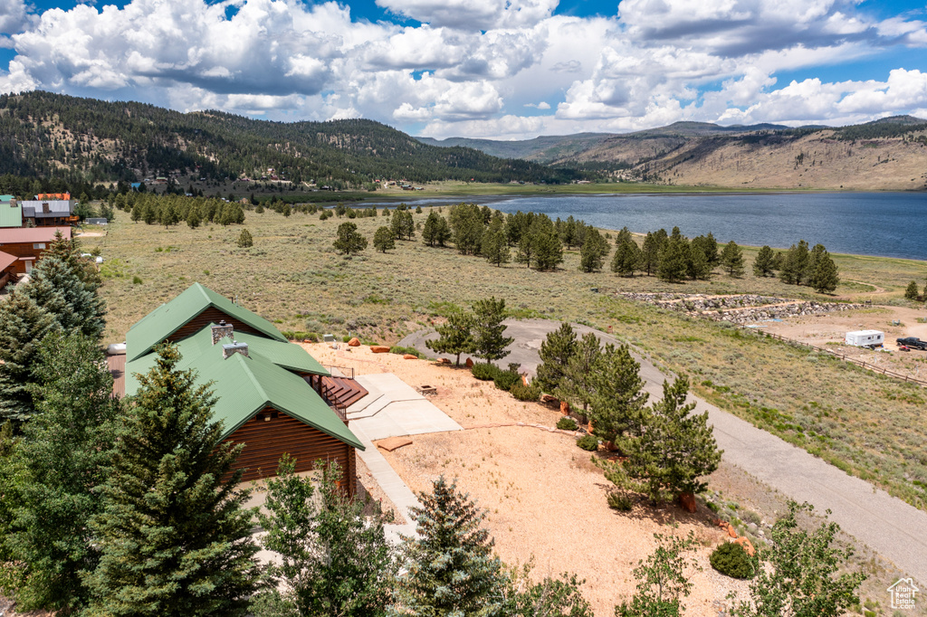 Birds eye view of property with a water and mountain view