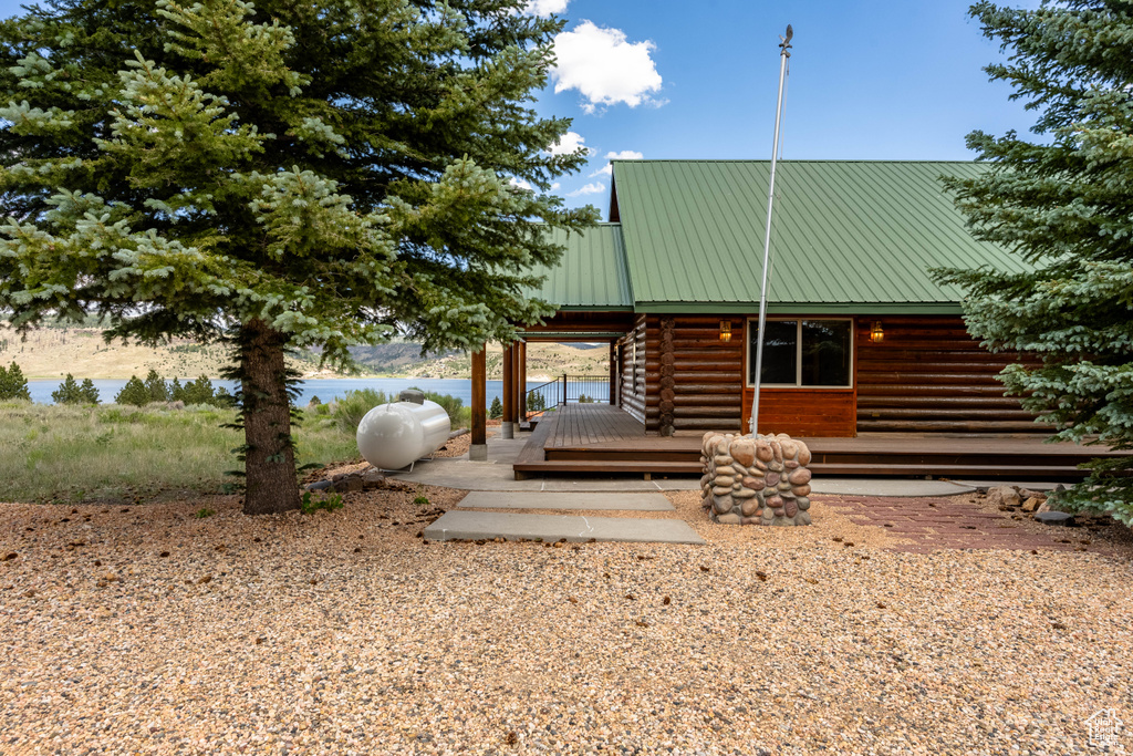 Log-style house featuring a wooden deck