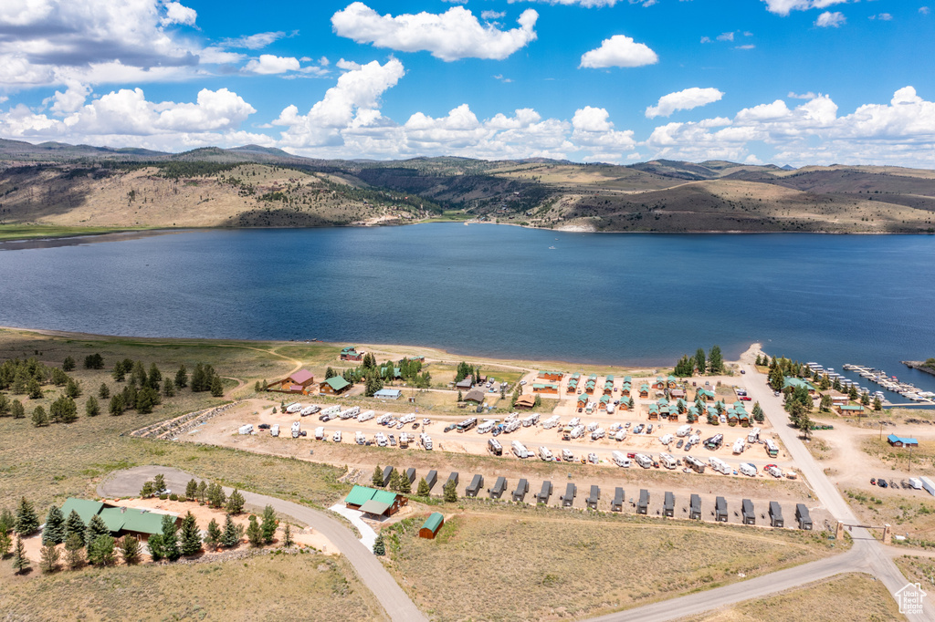 Drone / aerial view featuring a water and mountain view