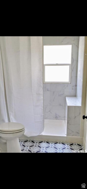 Bathroom featuring toilet and tile patterned floors