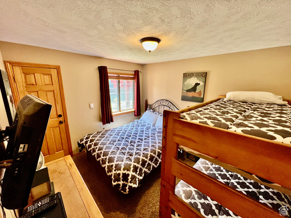 Bedroom with wood-type flooring and a textured ceiling