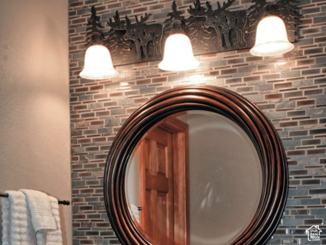 Bathroom featuring vanity and backsplash