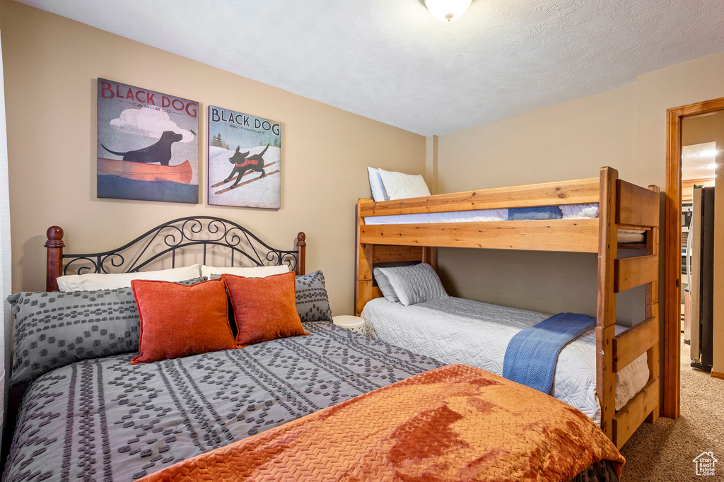 Bedroom featuring a textured ceiling and carpet floors