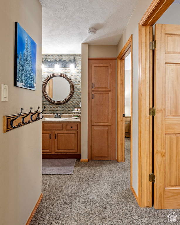 Bathroom featuring a textured ceiling and vanity