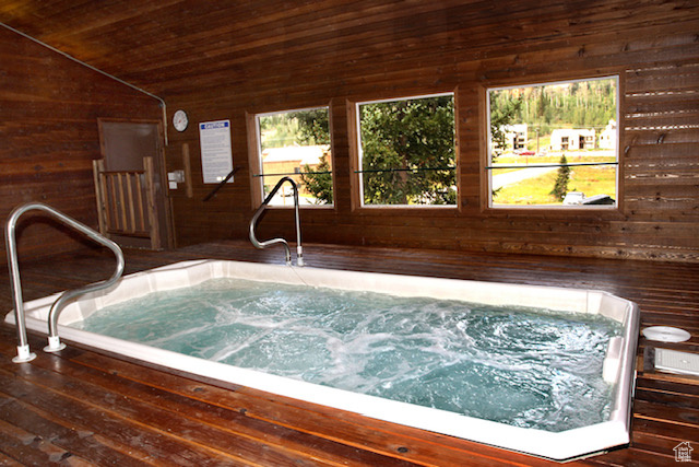 View of swimming pool featuring an indoor hot tub