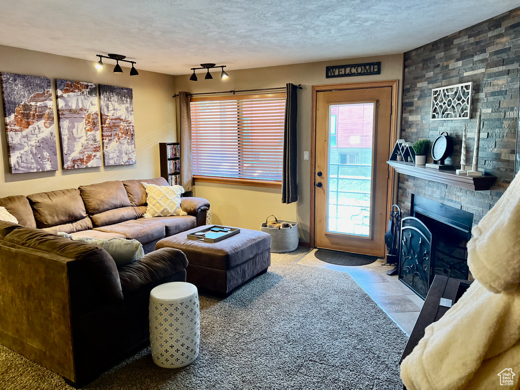 Living room featuring track lighting and a textured ceiling