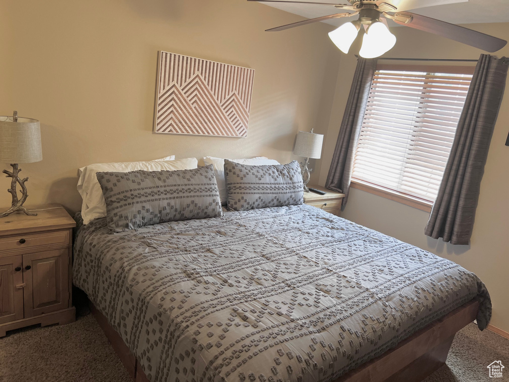 Carpeted bedroom with ceiling fan