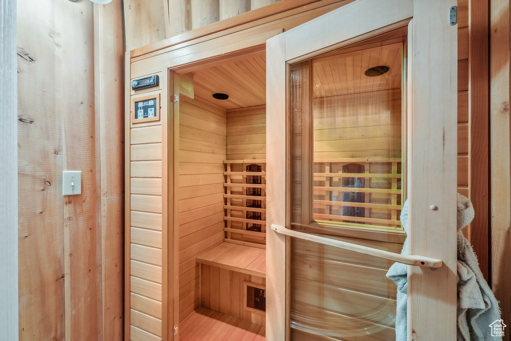 View of sauna / steam room with wood walls