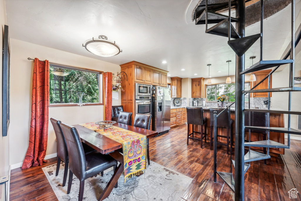 Dining space with dark wood-type flooring