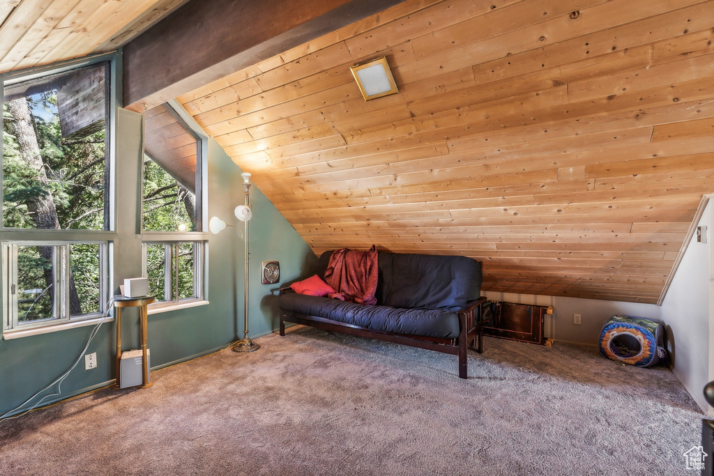 Sitting room featuring wooden ceiling, lofted ceiling, and carpet floors